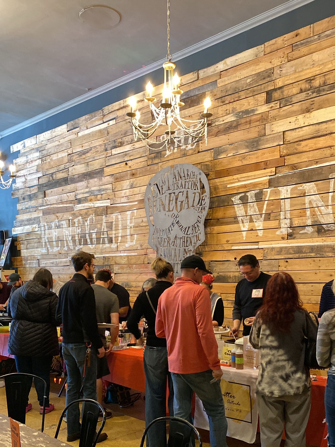 The first hungry attendees line up to get their plates filled with delicious chili! 