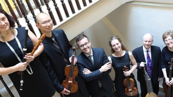 Six Orchestra Players Line Up in a Stairwell with Their Instruments